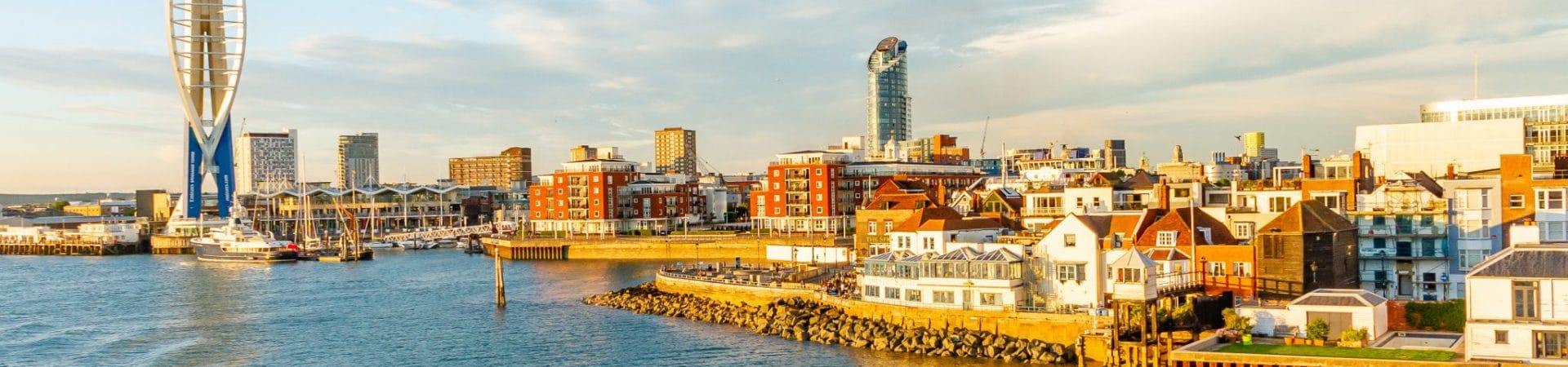 online vs classroom RYA theory — waterfront cityscape featuring Spinnaker Tower and modern buildings