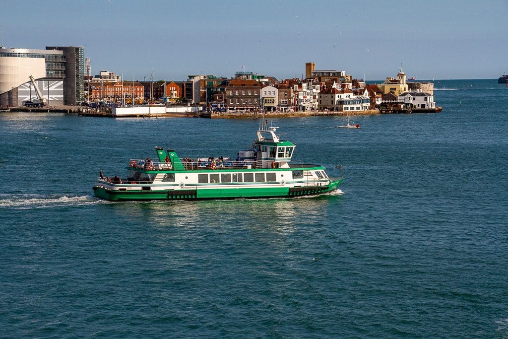 online vs classroom RYA theory — green ferry sailing near historic Portsmouth waterfront
