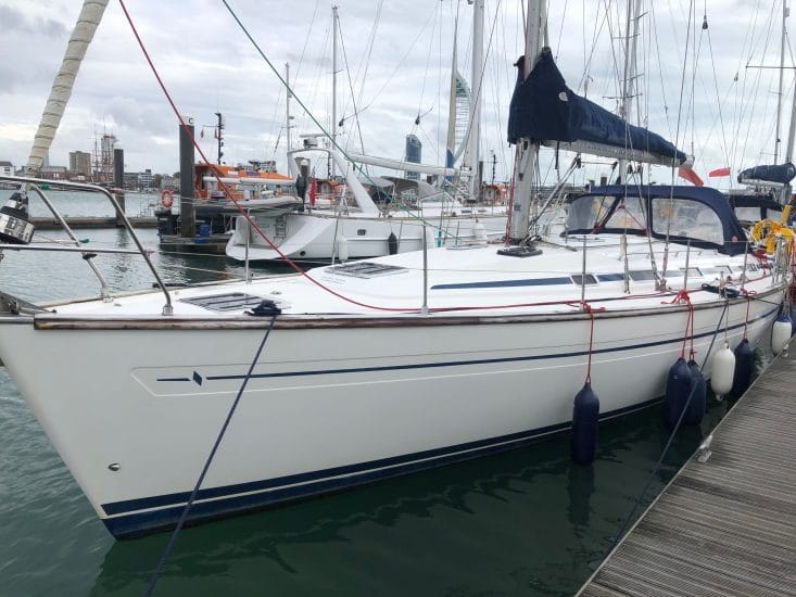 winterise boat Solent — white sailboat docked at marina with Spinnaker Tower in background