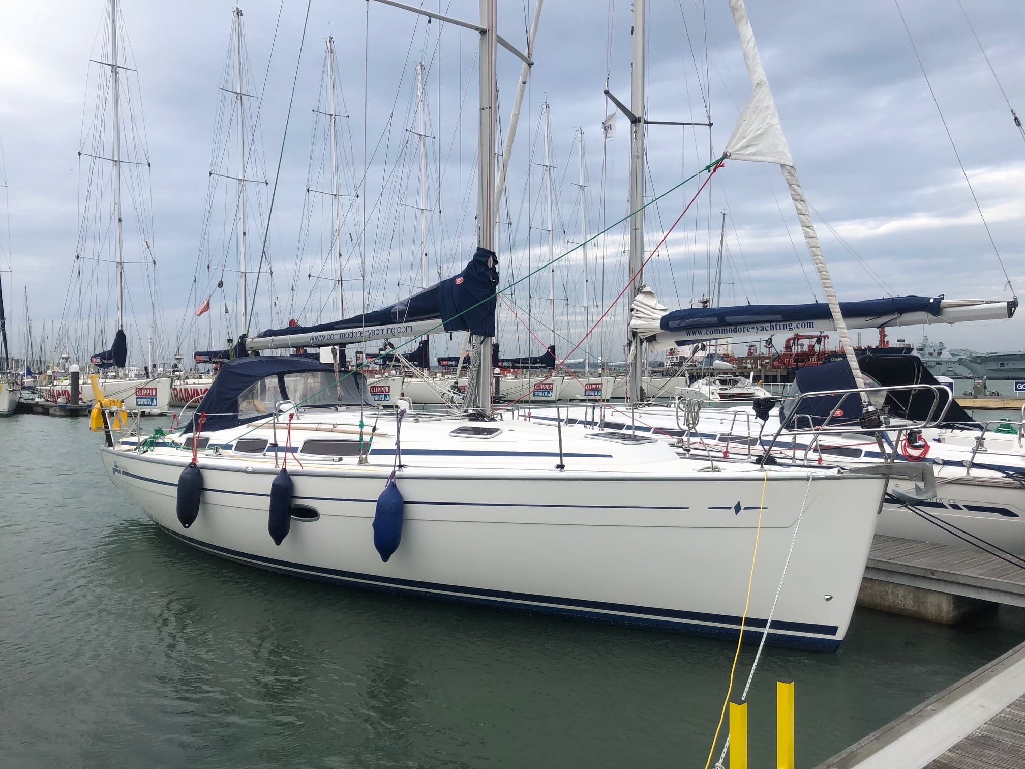 winterise boat Solent — marina with several sailboats docked under a clear sky