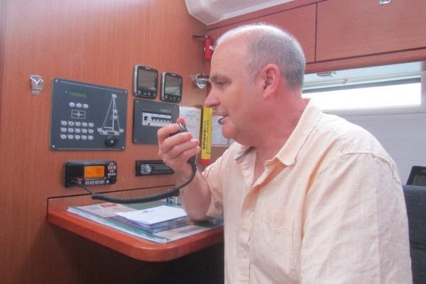 engine failure Solent — person using a radio communication device inside a boat cabin