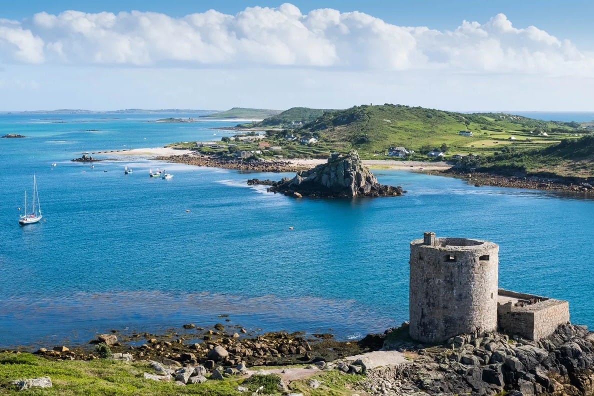solo sailing UK legal requirements — coastal landscape with clear blue waters and yachts