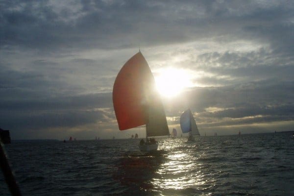 Christmas gift guide for sailors — sailing boats with colorful spinnaker sails racing on the ocean