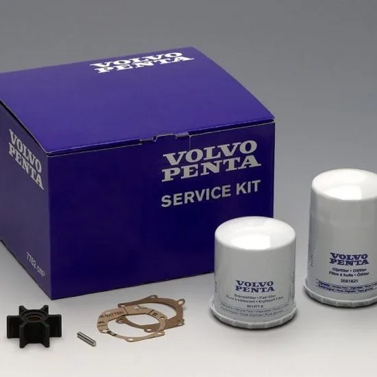 A Volvo Penta service kit with filters, gaskets, and small components displayed alongside a branded blue box on a plain background.